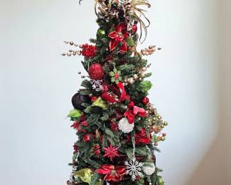 Completely decorated pre-lit Christmas tree and working condition . Sold as is with ornaments attached 