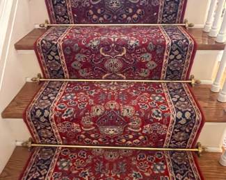 Carpet and brass holders on stairs