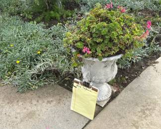 Sign-in sheet is near the front walk by the urn planters