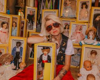 Owner of Estate Sales by Tara, Tara Daniel. Dolls in photo are not for sale