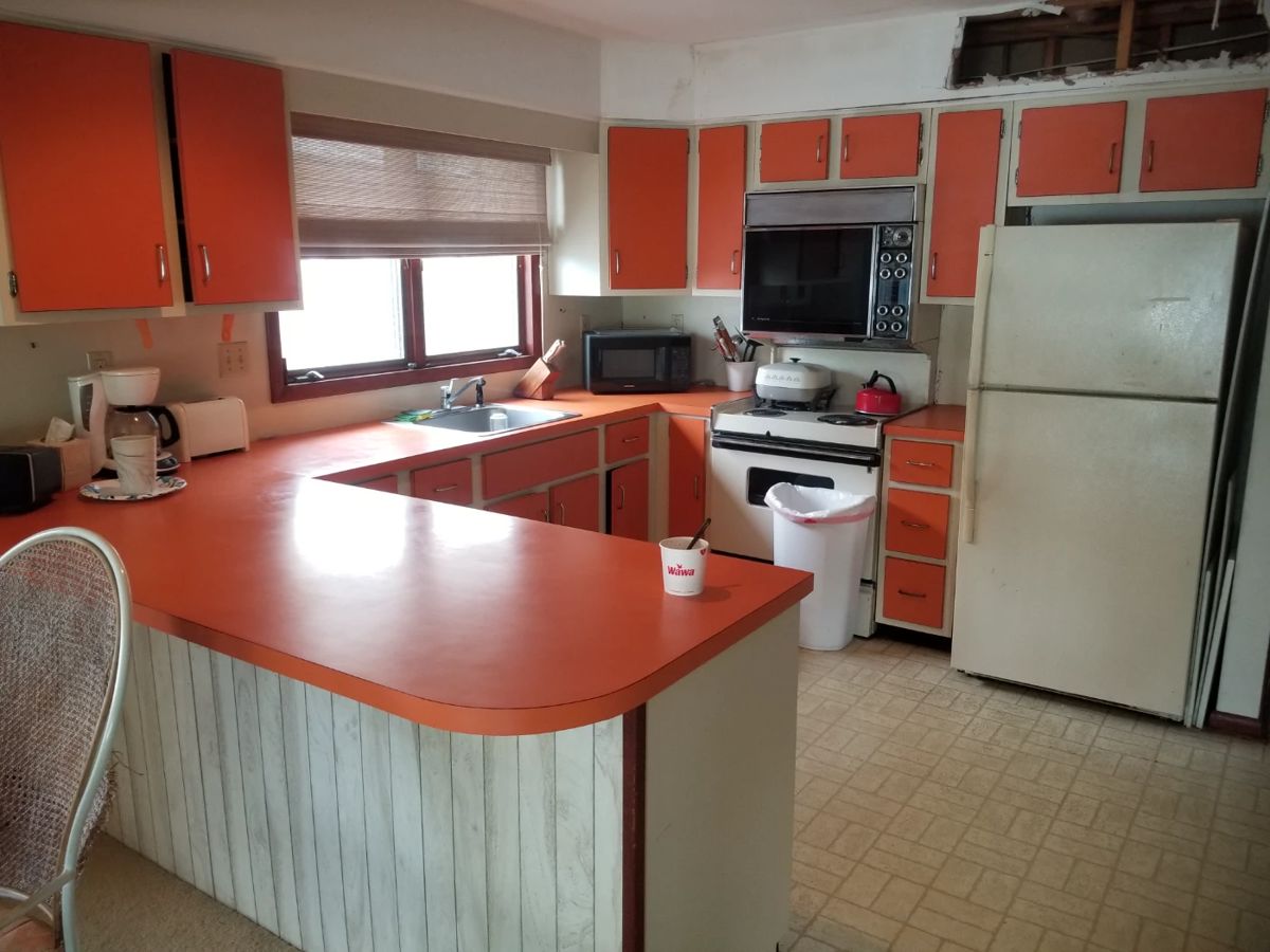 Original kitchen with orange Formica cabinets