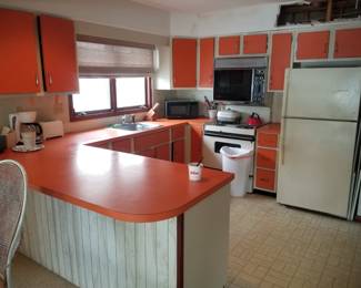 Original kitchen with orange Formica cabinets