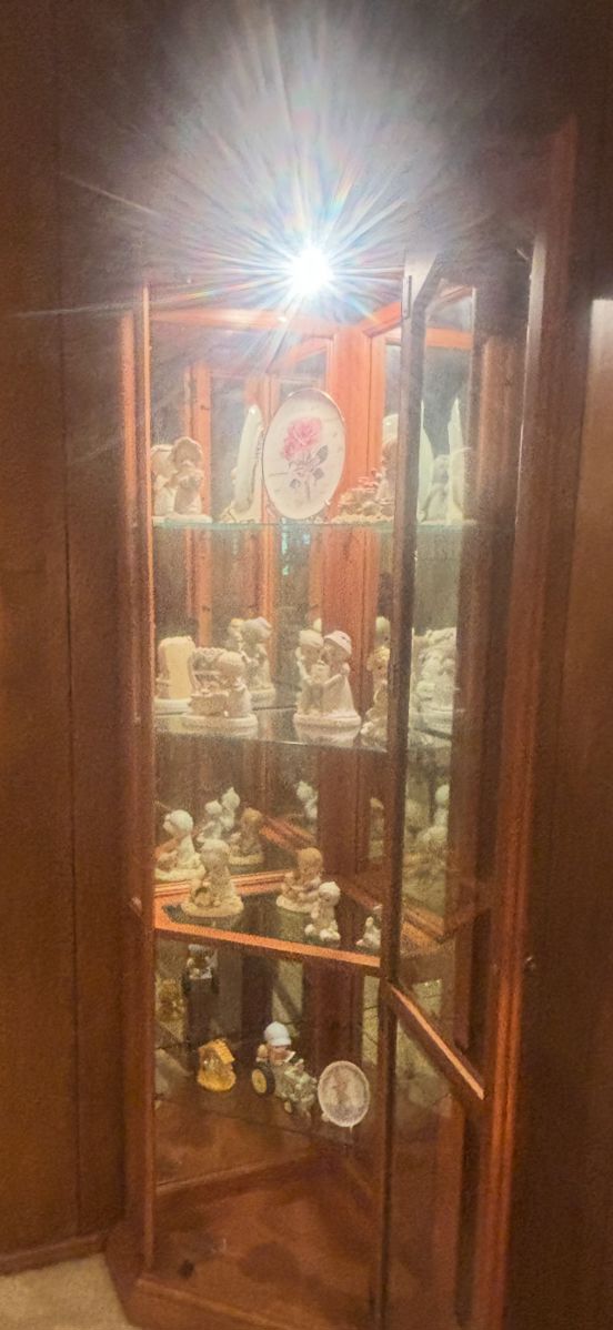 Lighted corner curio with several Precious Moments figurines