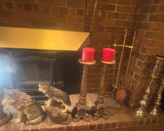 Lots of candlesticks. 2 heavy wolf figurines, brass fireplace set