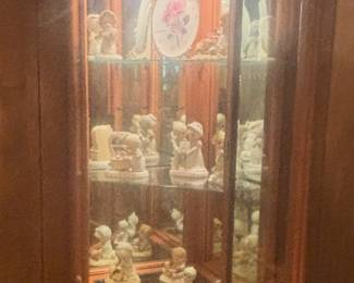 Lighted corner curio with several Precious Moments figurines