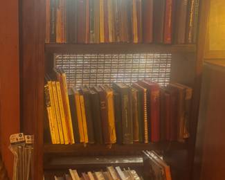Lots of books, hymnals and cookbooks and bookcase