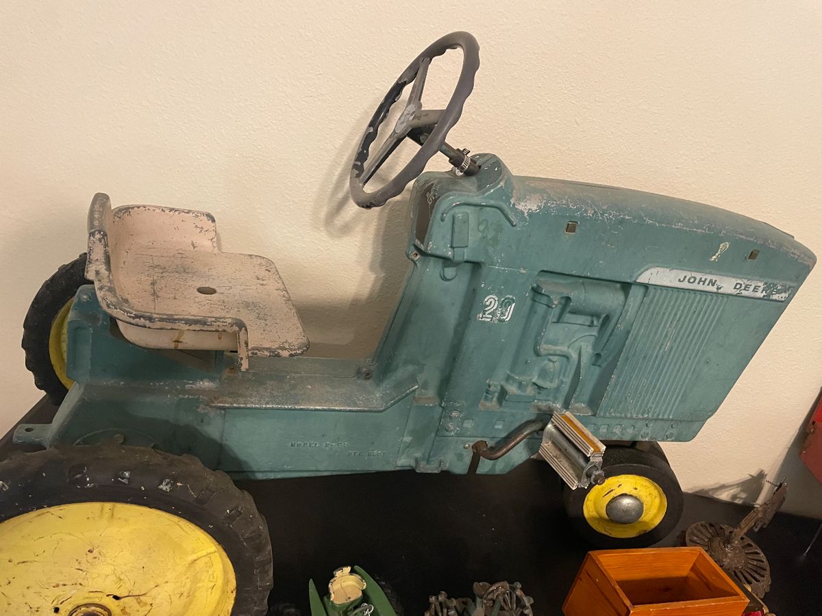 Vintage John Deer Kids Pedal Tractor Model D-63 DTC 6301 The John Deere D-63 is not a Model D tractor but is part of the "Model 20" series, and it is a vintage toy pedal tractor, with models like the "early D-63" being from the early 1960s