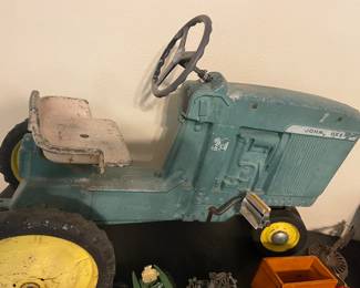 Vintage John Deer Kids Pedal Tractor Model D-63 DTC 6301 The John Deere D-63 is not a Model D tractor but is part of the "Model 20" series, and it is a vintage toy pedal tractor, with models like the "early D-63" being from the early 1960s