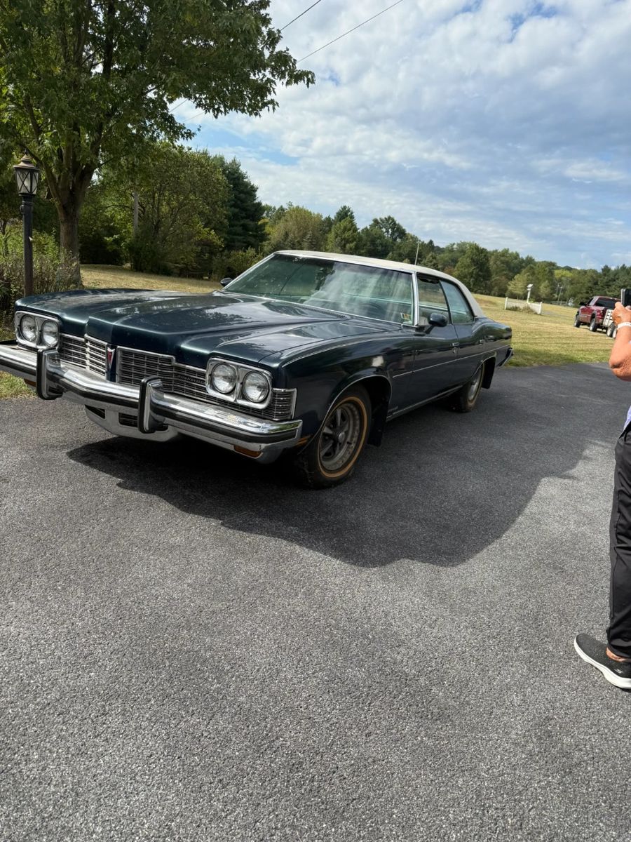 It’s a 1973 Pontiac Bonneville with 63,000 miles and a pristine white interior.  