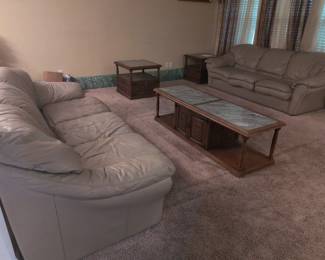Two grey leather couches $200; One coffee table with marble inlay; $200; Two matching end tables with grey marble inlay $100.