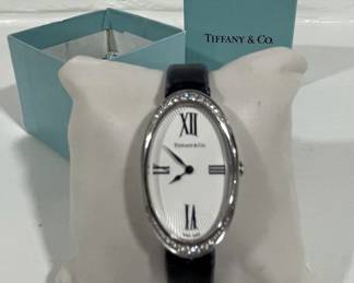 TIFFANY & CO
LADIES COCKTAIL WRISTWATCH STAINLESS STEEL,  BLACK LEATHER BAND+ DIAMOND ACCENT WHITE DIAL SAPPHIRE CRYSTAL 21MM OVAL 