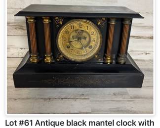 Antique black mantel clock with ornate gilt dial and decorative columns – early 1900s