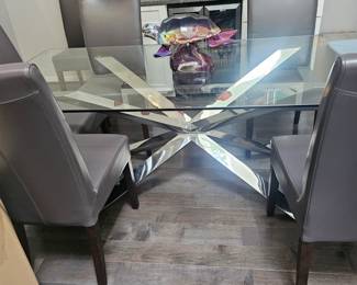 ZGallerie Modern Glass and Chrome Dining Table. 79 x 39.5. Seats 8. Also have 8 Crate And Barrel leather dining chairs as seen in photos and listed separately. Modern and chic statement piece! Makes the room look bigger! $700