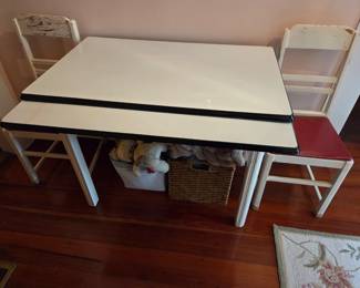 Vintage, not quite old enough to be antique, kitchen table. Pulls our on both sides with slotted drawer for silverware and 4 chairs.