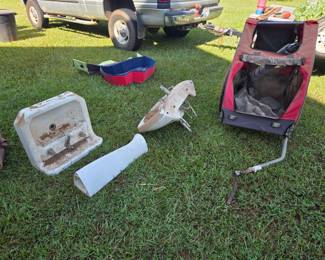 Dog pools, 2 sinks, one if from the 50s or 60s and a dog carrier meant to be pulled behind a bicycle. 
