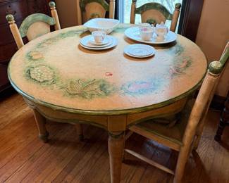 Country French- inspired kitchen table with four matching chairs.