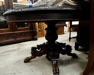 One of at least three round tables with gorgeous carved base. 