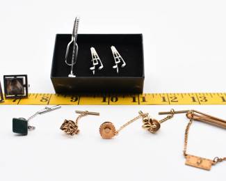lot of various cufflinks and tie tacks
