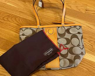 K24 - $25. Vintage Coach Canvas Khaki and Orange Tote with Dust Cover. Measures 14" x 4" x 10"