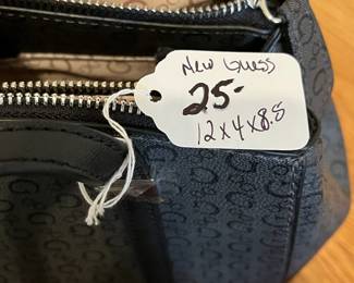 K26 - $25. New Guess Black and Grey Purse. Measures 12" x 4" x 8.5". 