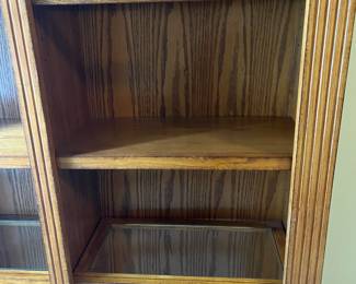 G5 - $150. Lighted Display Case / Bookshelf. Measures 48" x 15" x 84" tall. Center shelf is fixed the 8 other shelves are wood framed with glass inserts. All are adjustable. 