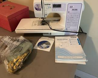 G7 - $100. Brother XR1300 Sewing Machine. Includes power cord, foot pedal & books. 
