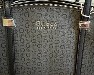 K26 - $25. New Guess Black and Grey Purse. Measures 12" x 4" x 8.5". 
