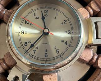 L46 - $40. Vintage Nautical Brass Porthole Clock in Wood Ship Wheel. Measures 13" across. 