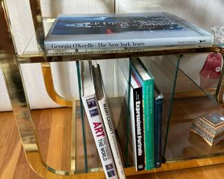 L3 - $750. Milo Baughman Brass and Glass 3 Tier Bar Cart. Measures 46.5" x 18" x 28" tall. The bottom right piece of glass has a chip we didn't notice until we were looking at it for issues. The glass could be replaced but if there is something near it you can't see it. 