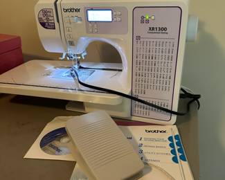 G7 - $100. Brother XR1300 Sewing Machine. Includes power cord, foot pedal & books. 