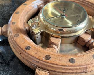 L46 - $40. Vintage Nautical Brass Porthole Clock in Wood Ship Wheel. Measures 13" across. 
