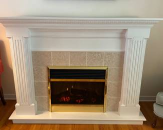 Fireplace with electric flame and heater insert.