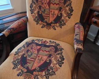 Antique or vintage fauteuil (an open-arm armchair) likely in the Louis XIV or Louis XV style, featuring tapestry upholstery with a heraldic or crest design