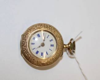 14 Kt. Gold Ladies Pendant/Pocket Watch Outer case marked 585, w/enamel insert
of cherubs. 1” Diameter. 19.6 grams total weight
