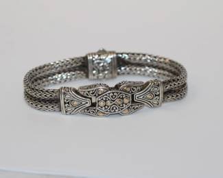 18kt yellow gold - .925 sterling designer Bracelet that features 3 central panels with 18k highlights and a double strand of sterling wheat chains ending in a hidden box clasp, bracelet is signed .925 18k ID and DSIN circle measures approx 7.25" in leng