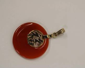 14kt yellow gold Red Jade Pendant that measures approx 1.5" long including the bale and approx 1" wide with Chinese writing in gold in center pendant, 2.3 grams total weight