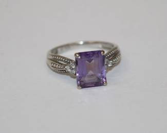 10kt yellow gold Amethyst and Diamond Ring that features an approx 2ct emerald cut purple amethyst and three round diamonds on each shoulder, total for all siz diaonds is approx .15ctw, size 7.25, 3.1 grams total weight