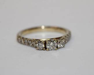 10kt yellow gold Past, Present, Future Diamond Ring by designer JST that features 3 central diamonds with 10 more diamonds down shoulders total diamond weight is approx 1.00ctw, it is hallmarked past, present, future on the inside of ring with dimaond be