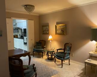 Everything for sale. Paintings, chairs, lamp, clock, side table.