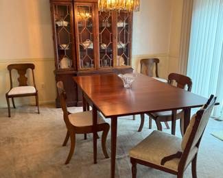 Mahogany dining table with 2 droplets sides.  4 Queen Ann chairs.  An ivory East Lake chair is at the head of the table.  Table also comes with 3 protective felt pads.