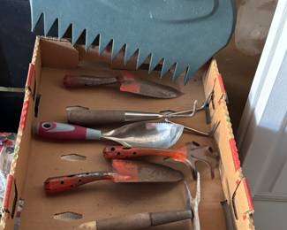 Lots of gardening tools, pots, shovels, spades, rakes