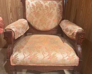 A pair of coordinating “Gentleman” and “Ladies” East Lake armchairs.  "His" shown here in the printed fabric.   “Hers” is similar. The wood is walnut and has beautiful detailed carvings.