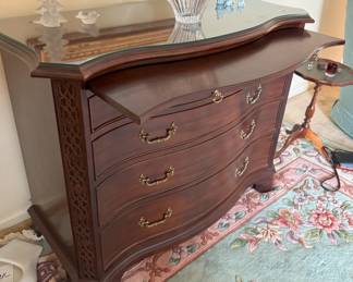 The writing surface pulled out and custom glass top. See the serpentine carving on the sides?  Dove tailed construction too. A quality piece.