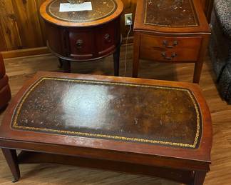Hollywood Regency. Itty bitty metal wheels on slender legs. There’s some wear and tear on the top that was designed to look like gilded leather. I love the round end table. 