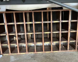 This amazing piece is an old U.S. Postal Service wall unit for separating mail! I used to do this with my Dad, as he worked for the USPO for almost 50 years and when I was little, he would let me load the boxes cause I knew everyone in town! Brass name plates, it would make a delightful headboard, wall unit for collectibles, so many things I can think of!!!