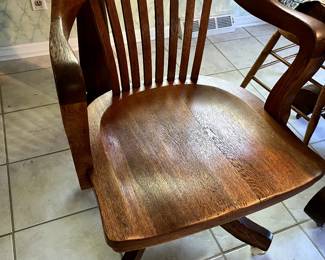 Solid oak Banker's chair on brass casters. This chair will outlast us all!