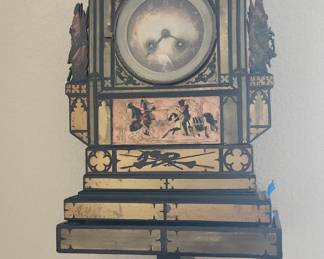 Wall Clock on pedestal, ca 1880
Size: 26 Inches ( 66cm) x 10 Inches ( 25.4cm)
Designs are cut out from copper and brass
and filled in with black filler and painted