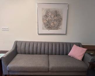Like new 3 seater couch displayed with antique wall hanging 