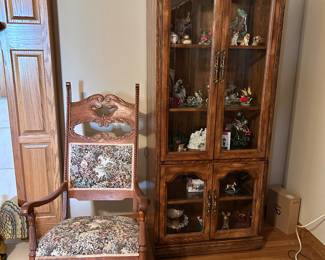Curio cabinet and upholstered chair.