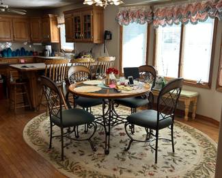 Dining table. Oval rug. Barstools.